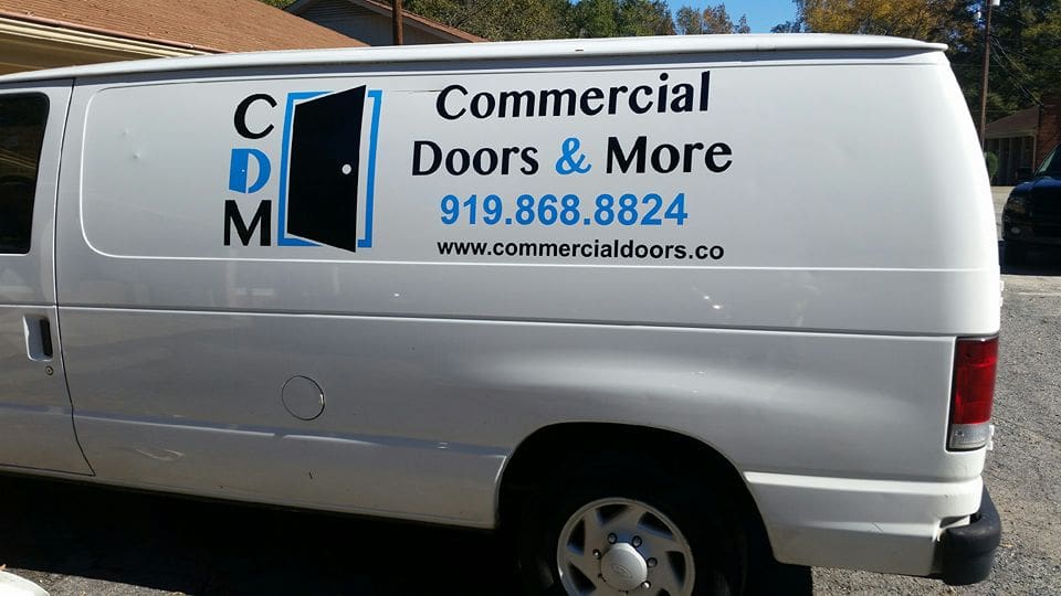 A commercial van parked in front of a building.